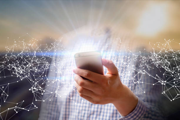 istock persons hand hold glowing modern smartphone, network concept background b 1146249535