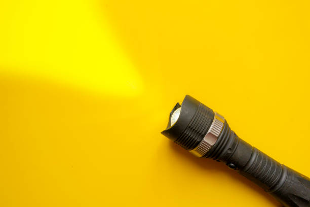 istock steel torch isolated on yellow surface, producing light beams or rays, copy space b 1146250333