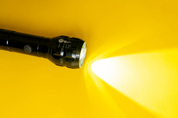 Close-Up Of Flashlight Over White Background