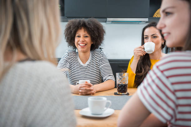 istock Group of friends talking in the kitchen and eating snacks 1146253599