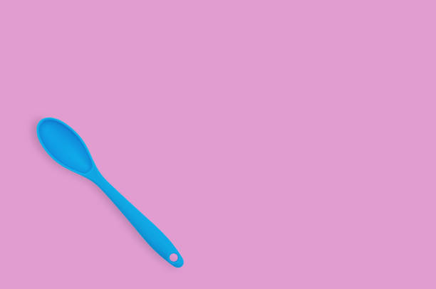 istock Blue rubber or silicone spoon with plastic handle for confectionery on pink table in kitchen. Flat lay. Copy space for your text 1146255325
