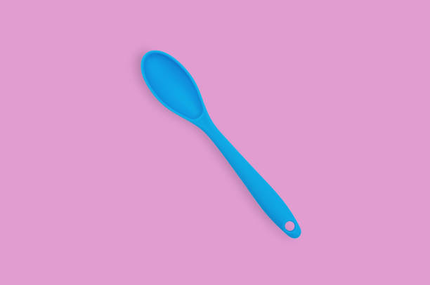 istock Blue rubber or silicone spoon with plastic handle for confectionery on pink table in kitchen. Flat lay 1146255327