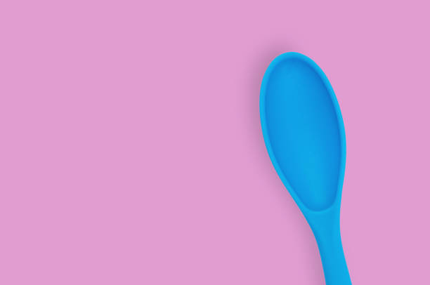 istock Blue rubber or silicone spoon with plastic handle for confectionery on pink table in kitchen. Flat lay. Copy space for your text 1146255329