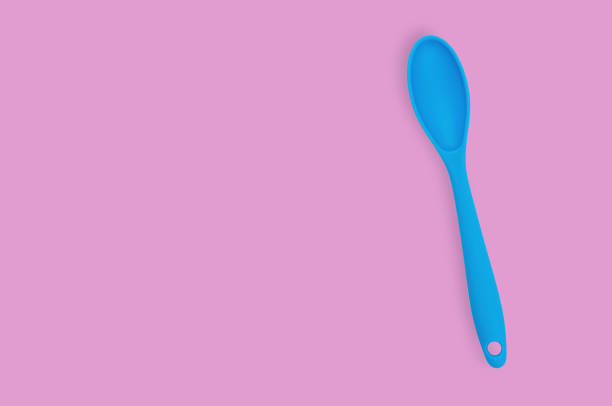istock Blue rubber or silicone spoon with plastic handle for confectionery on pink table in kitchen. Flat lay. Copy space for your text 1146255331