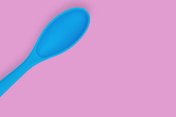 istock Blue rubber or silicone spoon with plastic handle for confectionery on pink table in kitchen. Flat lay. Copy space for your text 1146255332