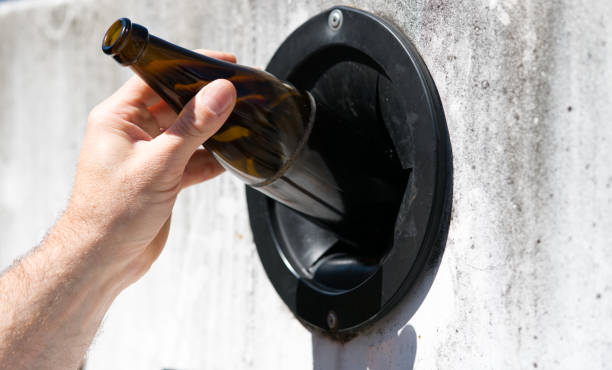 istock environmentally friendly man uses city facilities to recycle glass 1146255333