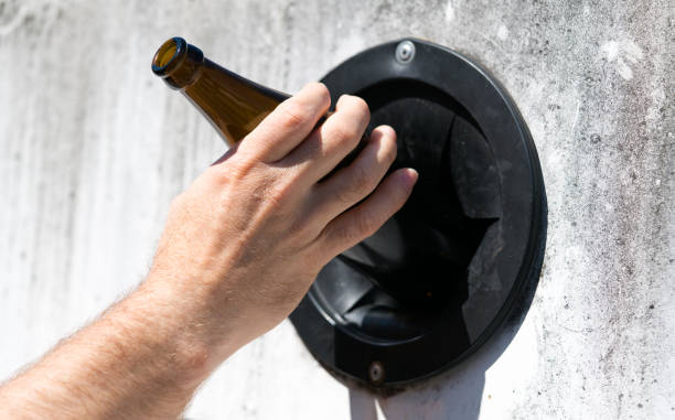 istock environmentally friendly man uses city facilities to recycle glass 1146256655