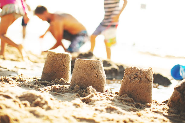 istock Children at the beach playing with sand 1146256677