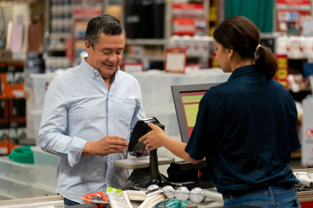 istock Man paying by card at the cashier at a hardware store 1146258936