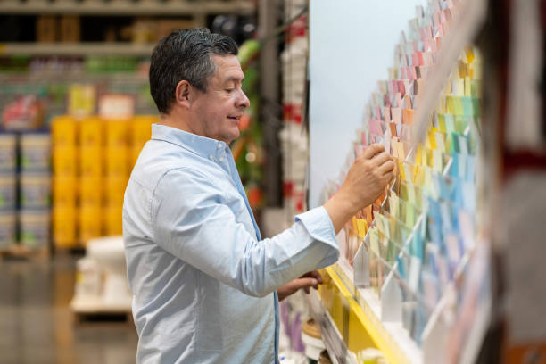 istock Man at hardware store choosing a color to paint his house 1146259051