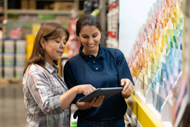 Photo of Woman at a home improvement store choosing paint colors