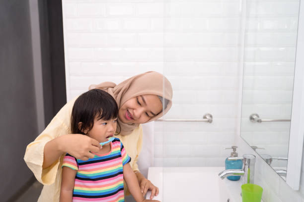 istock mother and her daughter brushing teeth 1146259391