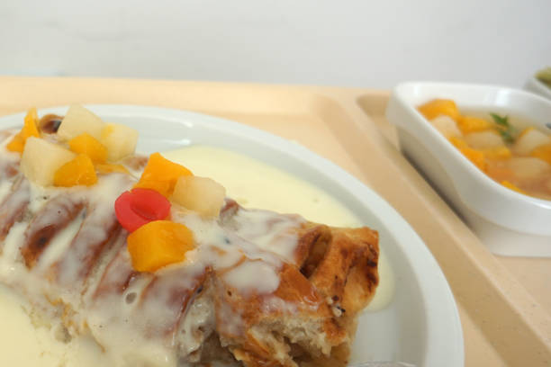 This is a apple strudel with custard and fruit salad in a canteen in Germany