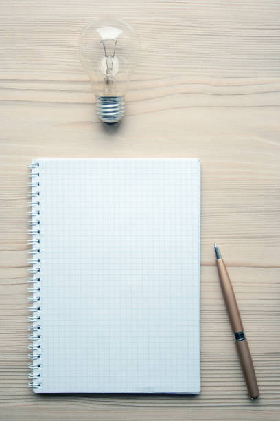 istock Pad and light bulb above them. Idea and creativity concepts. Brainstorming symbol 1146260750