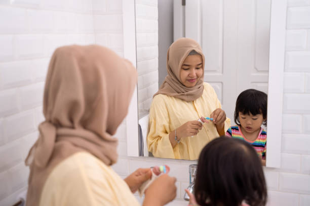 istock mom put some tooth paste on for her toddler brushing teeth 1146261111