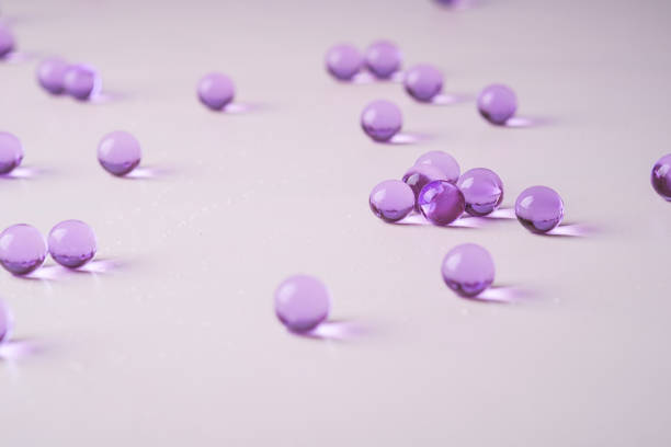 istock Purple scattered marbles on white background close up 1146262004