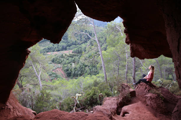 istock Young woman meditates in cave 1146262386