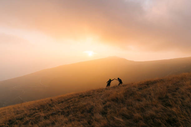 istock Mountain bikers give high-five at sunset 1146262464