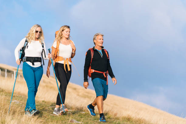 istock Family hikes down grassy hill 1146262497
