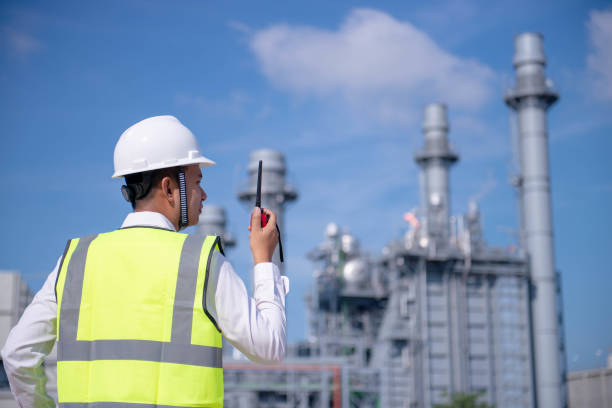 engineers use radio communication with factory worker. they work at the power plant - building contractor engineer digital tablet construction imagens e fotografias de stock