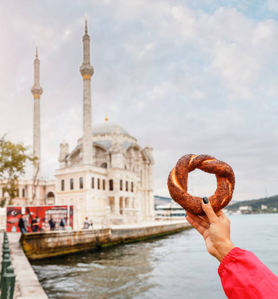 istock turkish simit bread with Ortakoy Mosque on background 1146263988