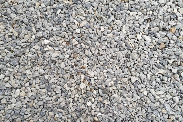 istock small road stone background, dark gravel pebbles stone texture seamless texture 1146264743