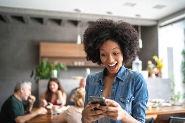 Surprised young woman holding a cellphone