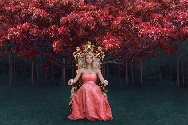 Fantasy concept of queen sitting on the throne in magical forest Fantasy concept of queen in luxury pink dress sitting on the throne in magical forest pink gown stock pictures, royalty-free photos & images