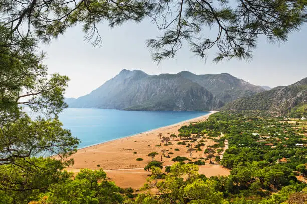 Aerial panoramic view of one of the most beautiful beaches in the world and Turkey - Cirali or Chirali near Antalya, surrounded by majestic mountains and the Mediterranean Sea