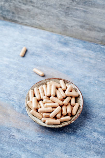 istock Cat's Claw (Uncaria tomentosa)  Extract Capsules. A Dietary Supplement. Immune System Support. Rustic wooden background. Copy space. 1146273766