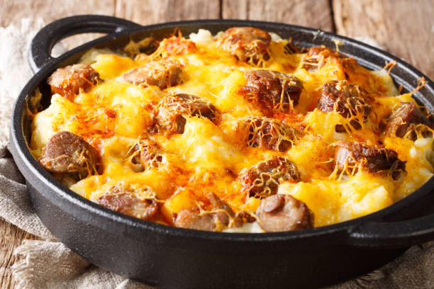 Main course from Cheese Potato and Smoked Sausage Casserole closeup on the pan. horizontal Main course from Cheese Potato and Smoked Sausage Casserole closeup on the pan on the table. horizontal hot breakfast stock pictures, royalty-free photos & images