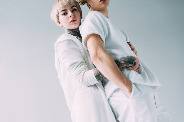 istock blonde girlfriend with tattoos hugging boyfriend isolated on grey 1146274687