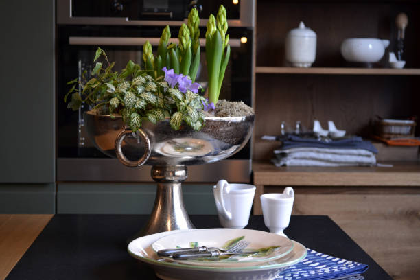 istock The vase with flowers and dishes on a kitchen table. 1146277571