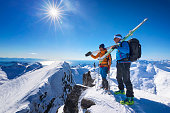 Two buddies  on top of a mountain peak,  Lofoten - Norway
