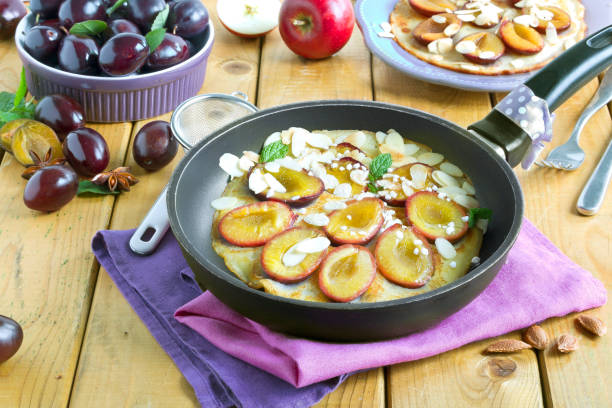 Pancakes with plums gluten-free in frying pan