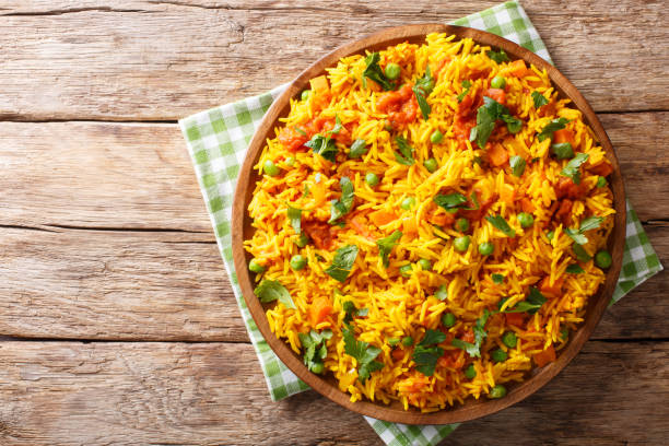 Indian food Tawa Pulao rice with vegetables and spices close-up. horizontal top view Indian food Tawa Pulao rice with vegetables and spices close-up on a plate. horizontal top view from above basmati rice stock pictures, royalty-free photos & images