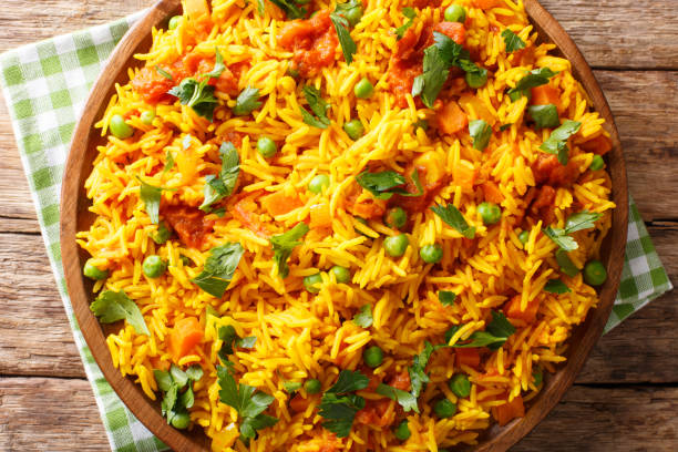 istock Vegetarian Indian rice with vegetables close-up on a plate. horizontal top view, rustic style 1146290745