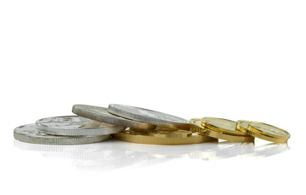 istock Gold and silver coins in close up isolated on white background with reflection 1146298096