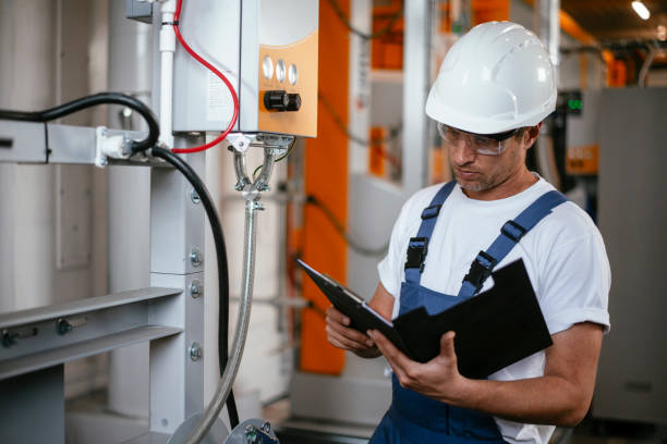istock Engineer. Factory worker. Refinery. Handsome factory worker controlling production. 1146299522