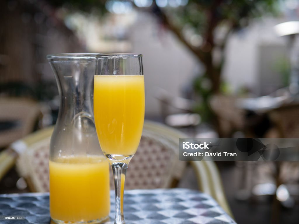Orange Juice Mimosa Drink In Glass And Carafe For Brunch Outdoors Stock  Photo - Download Image Now - iStock
