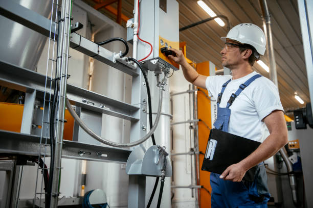 istock Engineer. Factory worker. Refinery. Handsome factory worker controlling production. 1146302091