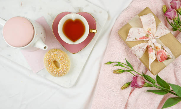 Feminine leisure, Sunday morning or relaxation flat lay overhead. Feminine leisure and relaxation flat lay overhead, sunday morning brunch, Mother's Day, birthday or Valentine's celebration. pink tea stock pictures, royalty-free photos & images