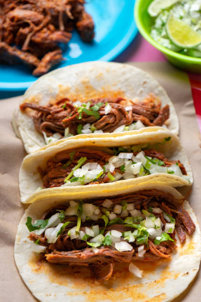 istock Mexican beef barbacoa tacos on colorful background 1146304455