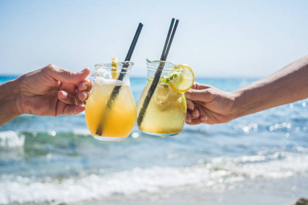 istock Two cocktail glasses in hands 1146305361
