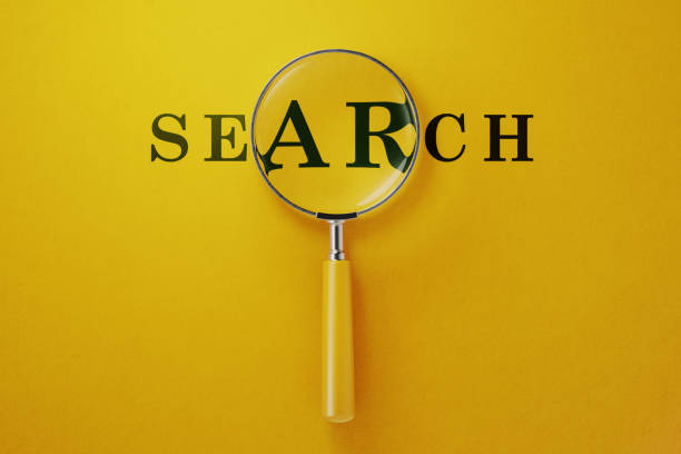 istock Magnifier And Search Text On Yellow Background 1146305482