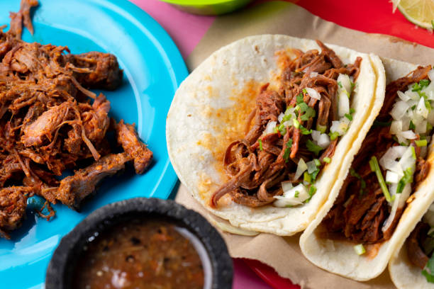 istock Mexican beef barbacoa tacos on colorful background 1146305531