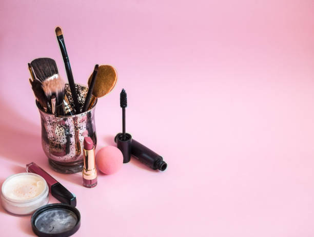 istock Make up brushes in a glass on pink background. Space for text. 1146305750