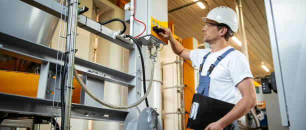 istock Engineer. Factory worker. Refinery. Handsome factory worker controlling production. 1146305968