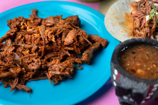 istock Mexican beef barbacoa tacos on colorful background 1146306024