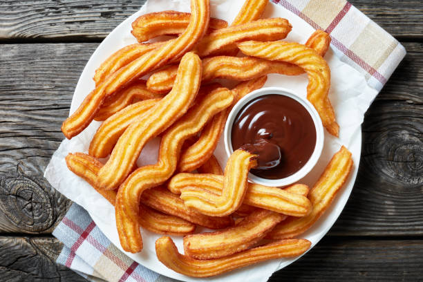 Traditional Spanish dessert churros on a white platter